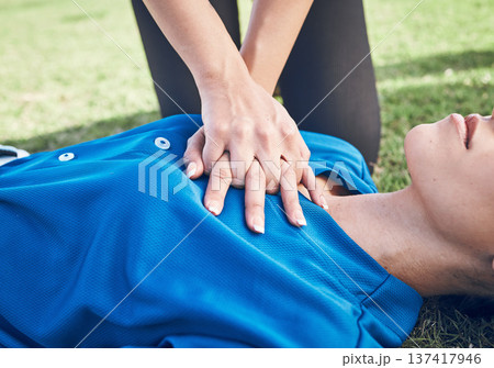 CPR, lung press and woman hands on field for sport, fitness and game with accident and emergency. Training, paramedic and medical help for breathe from injury with first aid and athlete outdoor CPR, lung press and woman hands on field for sport, fitness and game with accident and emergency. Training, paramedic and medical help for breathe from injury with first aid and athlete outdoor 137417946