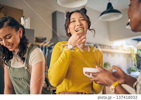Women, friends and eating healthy food in home for bonding, nutrition and happy lunch together. Fruit diet, sharing and wellness, fresh summer friendship and girls in kitchen with smile at party. 137418032