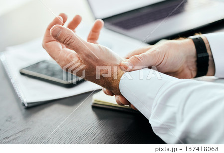 Business, wrist pain and hands of man in office holding for injury, inflammation and joint strain. Stress, medical emergency and closeup of worker with problem, crisis and carpal tunnel for writing Business, wrist pain and hands of man in office holding for injury, inflammation and joint strain. Stress, medical emergency and closeup of worker with problem, crisis and carpal tunnel for writing 137418068