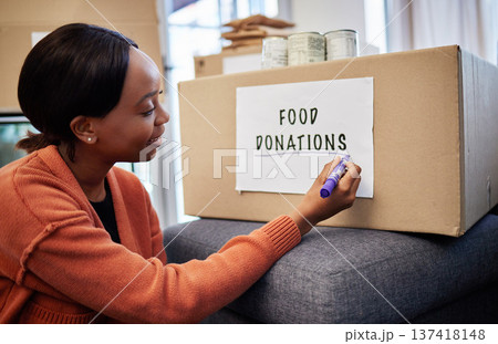 Food, donation and charity with black woman and box for volunteer, helping and support. Grocery, community service and hope with person at home for ngo package, nonprofit and social responsibility Food, donation and charity with black woman and box for volunteer, helping and support. Grocery, community service and hope with person at home for ngo package, nonprofit and social responsibility 137418148