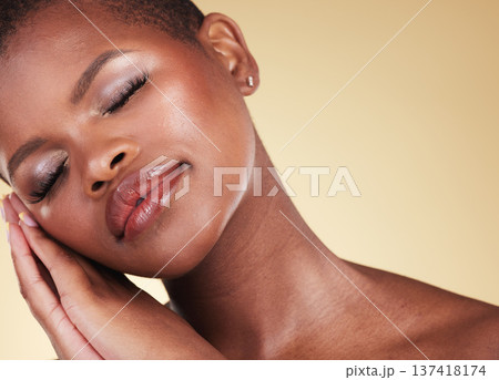 Makeup, black woman and face with beauty in studio for skin care, glow and cosmetics. Headshot of african person or aesthetic model with facial shine, dermatology and wellness on a beige background 137418174