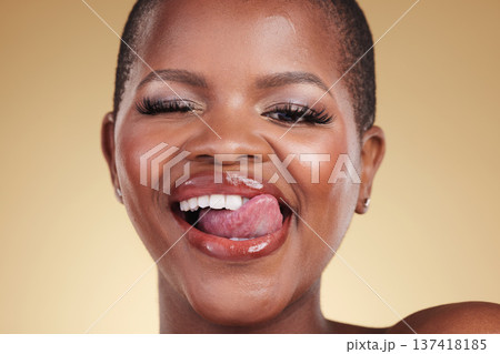 Wink, lick lips and beauty of a woman in studio for skin care, makeup and cosmetics. Face of a happy african model person with facial shine, dermatology and wellness or flirting on a beige background Wink, lick lips and beauty of a woman in studio for skin care, makeup and cosmetics. Face of a happy african model person with facial shine, dermatology and wellness or flirting on a beige background 137418185