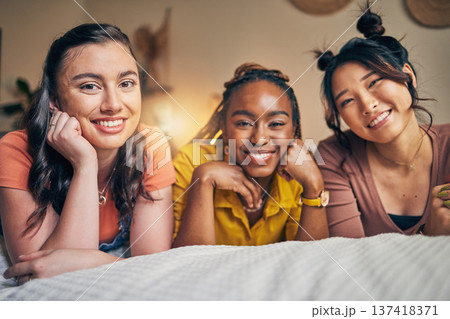 Portrait of women, friends on bed with smile and bonding in apartment together in support, trust and solidarity. Relax, love and friendship, girls in bedroom with diversity, pride and people in home. Portrait of women, friends on bed with smile and bonding in apartment together in support, trust and solidarity. Relax, love and friendship, girls in bedroom with diversity, pride and people in home. 137418371