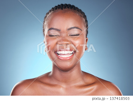Beauty, skincare and black woman with laughing, cosmetics and makeup in studio. Wellness, African female model and funny with blue background and skin glow with shine from dermatology and treatment 137418503