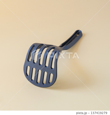 Black potato masher on background. Kitchenware. Pusher for mashed potatoes. 137419279