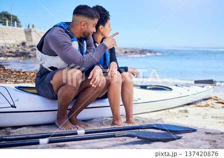 Couple, talking and outdoor for kayak or travel at a beach with a partner for teamwork. A man and woman with a canoe for sports, water adventure and vacation or freedom pointing at space in nature 137420876