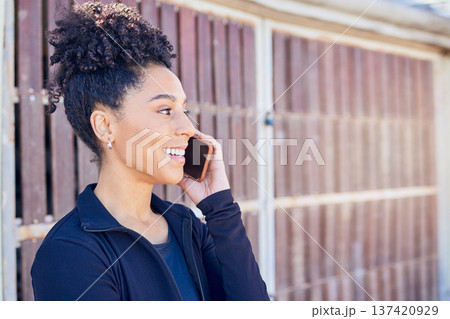 Phone call, communication and young woman outdoor talking with smile and happiness on technology. Fitness, cellphone and female athlete on a mobile conversation after an outside workout or exercise. Phone call, communication and young woman outdoor talking with smile and happiness on technology. Fitness, cellphone and female athlete on a mobile conversation after an outside workout or exercise. 137420929