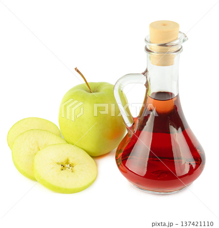 Glass Carafe of Red Vinegar with Fresh Green Apple Slices 137421110