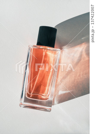 Perfume bottle showcasing fragrance and elegance with abstract light and shadow patterns 137422007