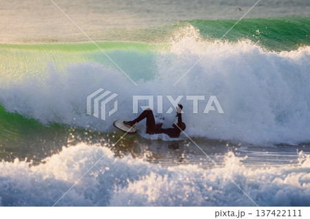 Surfer fell in powerful ocean wave. Surfing action and wipeout moment. Surfer fell in powerful ocean wave. Surfing action and wipeout moment. 137422111