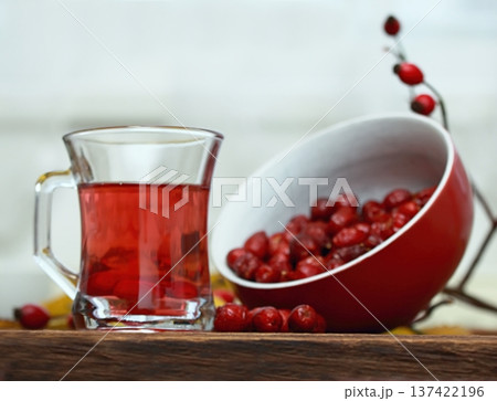 Rosehip tea tea full of vitamins and bowl with dried rosehips. 137422196