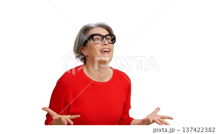 Senior woman reacting with surprise looking up Senior woman reacting with surprise looking up 137422382