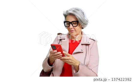 Senior woman using phone and listening music Senior woman using phone and listening music 137422392