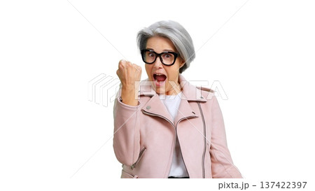 Excited senior woman celebrating success with triumphant fist pump Excited senior woman celebrating success with triumphant fist pump 137422397