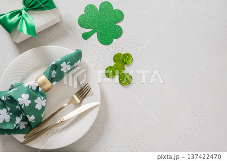 St Patricks day table setting with green shamrock,clover, traditional symbols St Patricks day table setting with green shamrock,clover, traditional symbols 137422470