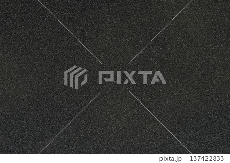 Black sandpaper texture with rough surface showing fine grain details clearly Black sandpaper texture with rough surface showing fine grain details clearly 137422833