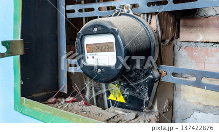 An old electric meter displaying the electricity consumed in an old industrial building. Part of an electrical panel. Measuring used electricity 137422876