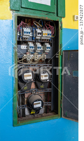Electrical meter with distribution fuse board in old industry building. Electrical background. 137422877