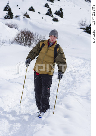 Man walking in snowy mountain forest landscape in winter.  Kazakhstan 137422888