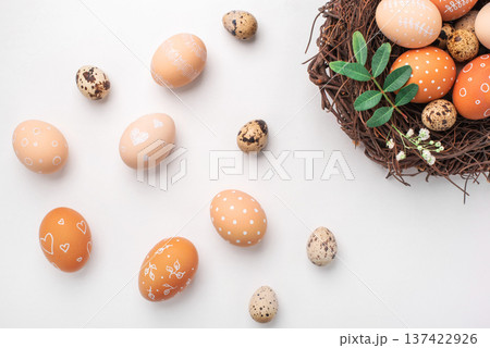 Easter nest with hand-painted eggs on a light background Easter nest with hand-painted eggs on a light background 137422926