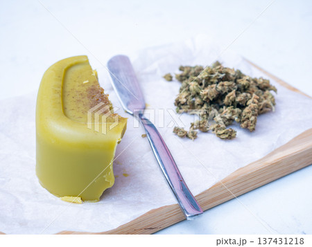 homemade cannabis butter and dried marijuana flower buds on a white background, medicinal cannabis and edible concept. 137431218