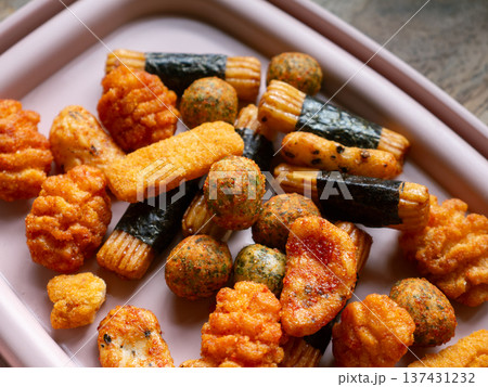 Assorted Japanese Rice Crackers and Snacks Mix Arare Senbei with Seaweed on White Plate - Traditional Asian Savory Snack Food Assorted Japanese Rice Crackers and Snacks Mix Arare Senbei with Seaweed on White Plate - Traditional Asian Savory Snack Food 137431232