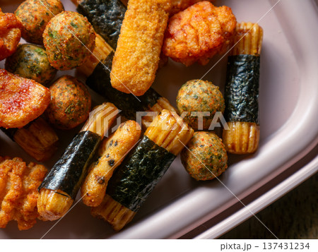 Assorted Japanese Rice Crackers and Snacks Mix Arare Senbei with Seaweed on White Plate - Traditional Asian Savory Snack Food Assorted Japanese Rice Crackers and Snacks Mix Arare Senbei with Seaweed on White Plate - Traditional Asian Savory Snack Food 137431234
