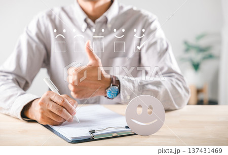 Satisfaction customer survey feedback shows excellent service review, person gives enthusiastic thumbs up, completes evaluation form, selects best emoji rating for positive experience, happy smiley Satisfaction customer survey feedback shows excellent service review, person gives enthusiastic thumbs up, completes evaluation form, selects best emoji rating for positive experience, happy smiley 137431469