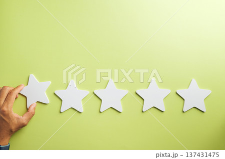 Hand places final five star review, illustrating customer feedback satisfaction for excellent service experience, online rating for quality business success and high survey rate 137431475