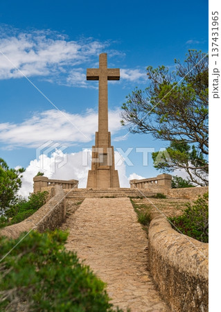Monumental Stone Cross Amidst Scenic Beauty in Mallorica, Spain A Symbol of Faith and History 137431965