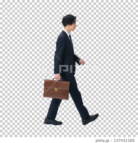 A male business person walking in a suit. A transparent, hand-cut, full-body PNG photo. 137432160