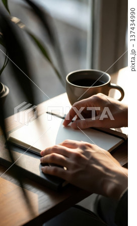 Blank notebook and coffee cup on sunlit desk 137434990