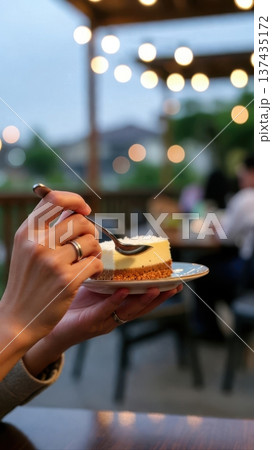 Cheesecake slice on plate in cozy evening cafe Cheesecake slice on plate in cozy evening cafe 137435172