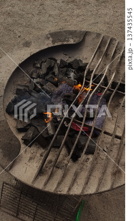 Burning charcoal in a grill getting ready for summer barbecue shashlik 137435545