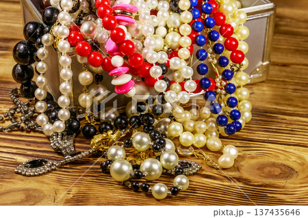 Jewelry box full of jewelry and accessories on wooden background 137435646
