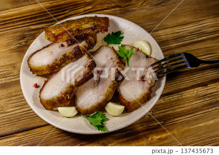 Baked pork belly in a plate on wooden table 137435673