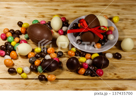 Easter composition with chocolate eggs on wooden background Easter composition with chocolate eggs on wooden background 137435700