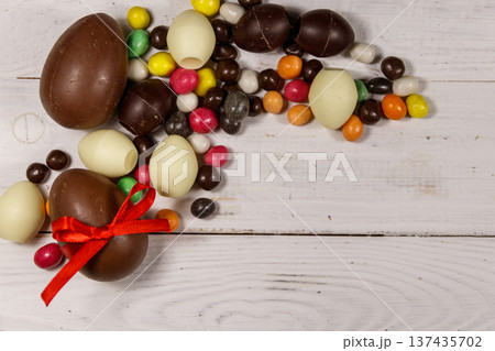 Easter composition with chocolate eggs on white wooden background Easter composition with chocolate eggs on white wooden background 137435702