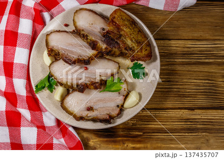 Baked pork belly in a plate on wooden table. Top view Baked pork belly in a plate on wooden table. Top view 137435707