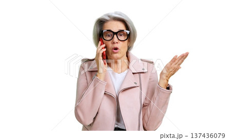 Senior woman talking on phone and gesturing discussion Senior woman talking on phone and gesturing discussion 137436079