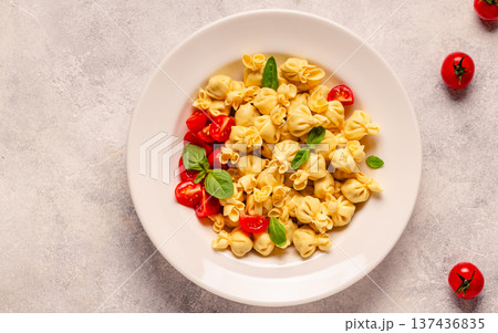pasta in a plate with tomato sauce. 137436835