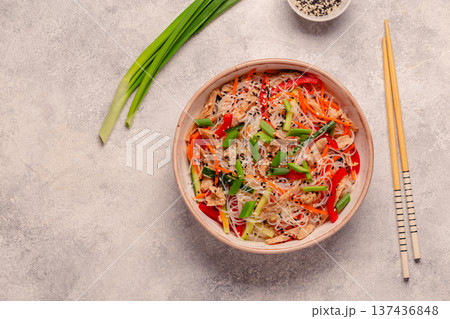 Bowl of rice noodles with vegan soy meat and vegetables. 137436848