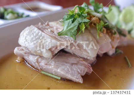 Close up of Singaporean poached chicken garnished Close up of Singaporean poached chicken garnished 137437431