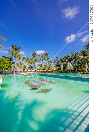 Luxury summer beach resort tropical poolside with palm trees golden sunshine spa wellness tropical vacation paradise relaxation travel destination 137437503