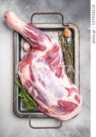 Uncooked fresh lamb shoulder leg with rich marbling, ideal for gourmet dishes and family feasts. grey background. top view Uncooked fresh lamb shoulder leg with rich marbling, ideal for gourmet dishes and family feasts. grey background. top view 137438218