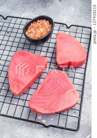 Premium raw tuna fillet steak, ideal for grilling or sashimi, a must-have for gourmet dishes and healthy meals. grey background. top view 137438219
