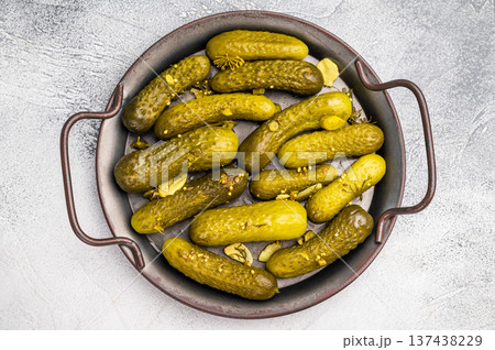 Freshly jarred dill pickles, a delightful addition to any meal or charcuterie board that adds a zesty crunch. grey background. top view Freshly jarred dill pickles, a delightful addition to any meal or charcuterie board that adds a zesty crunch. grey background. top view 137438229