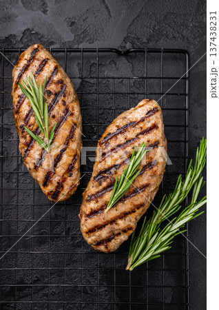 Grilled kofta kebabs made from spiced minced meat, perfectly grilled and served with fresh herbs and tangy sauce. black background. top view 137438231