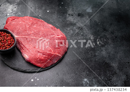 Fresh raw top sirloin steak, beautifully marbled and ready for grilling, perfect for meat lovers seeking quality. black background. top view 137438234