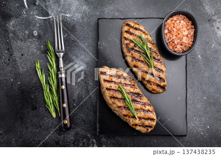 Grilled lula kebabs, perfect for an authentic Middle Eastern feast. black background. top view 137438235